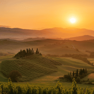 Golden sunrise over rolling hills and vineyards in Tuscany, Italy
